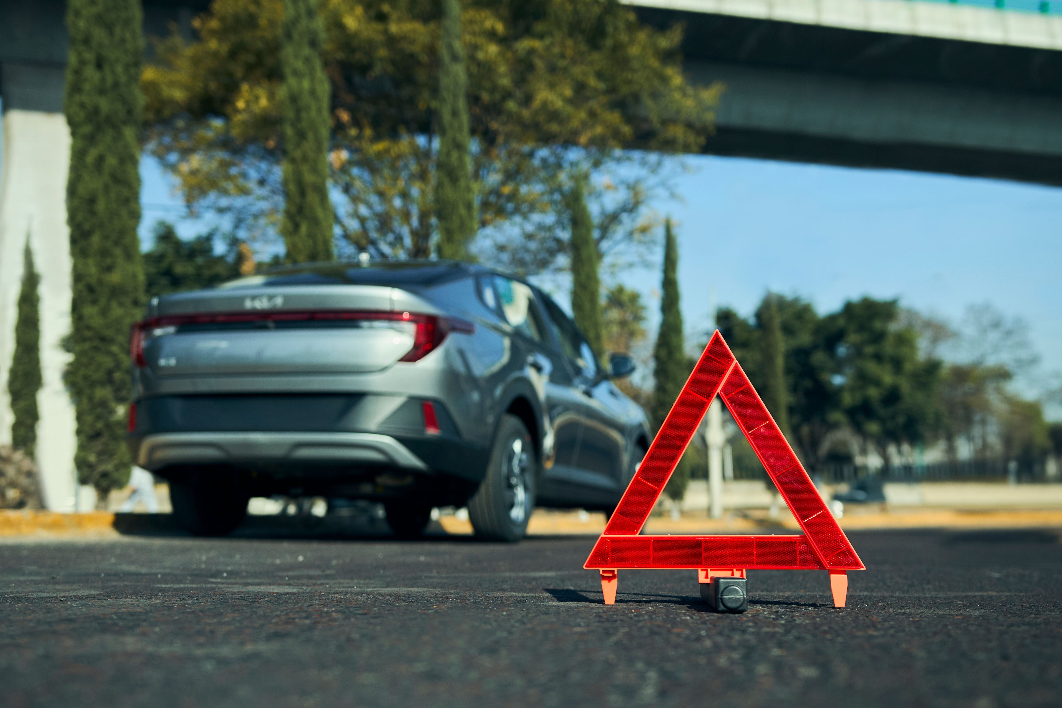 Close-up of emergency warning triangle sign on the road