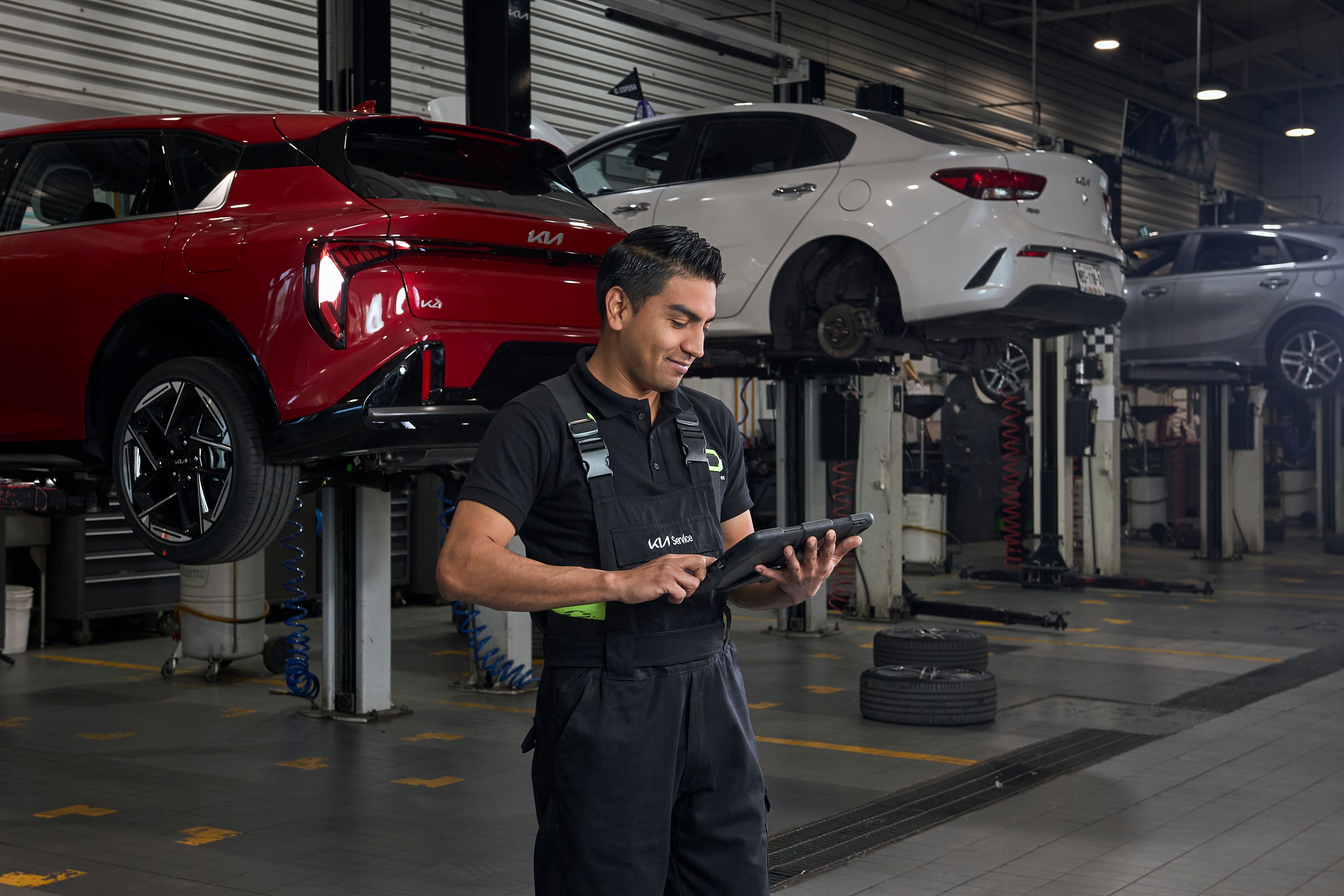 Mechanic inspecting a car with a long stick