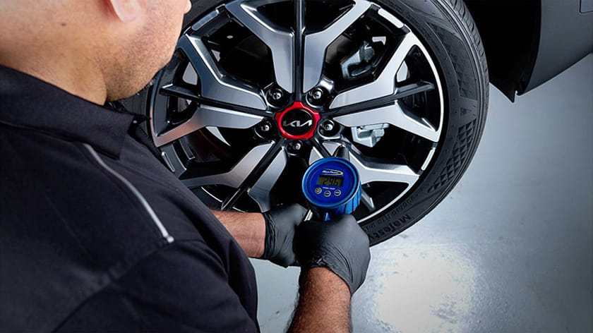 Man using mobile phone behind at a car